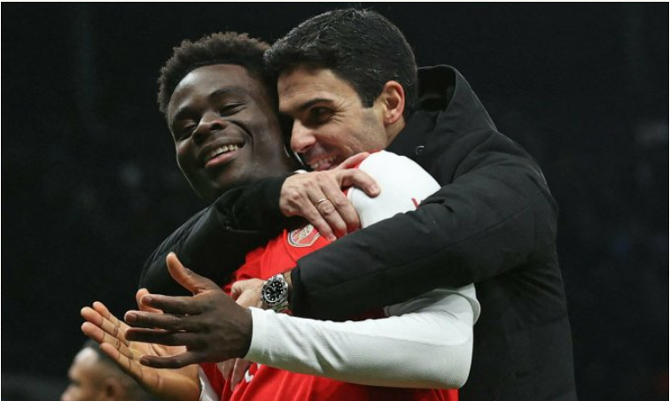 Arteta ôm học trò Saka khi Arsenal mừng chiến thắng trước Tottenham ngày 15/1.